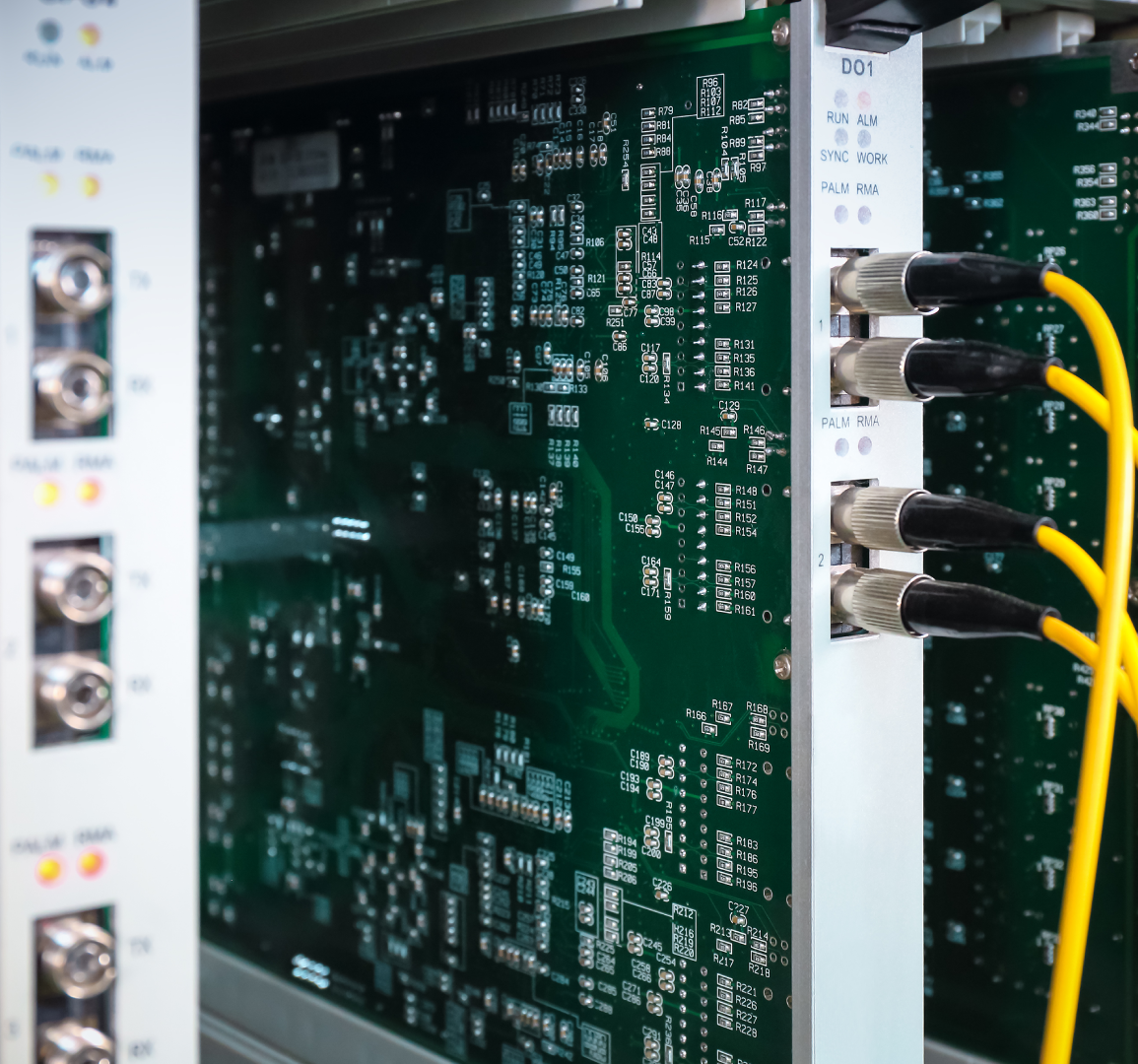 Circuit board with yellow cables and connectors.