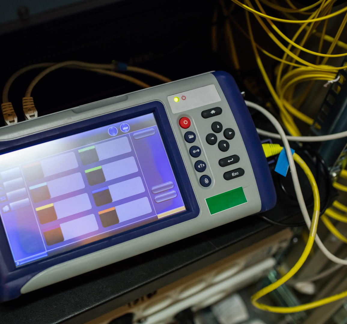 Network testing device with cables connected.