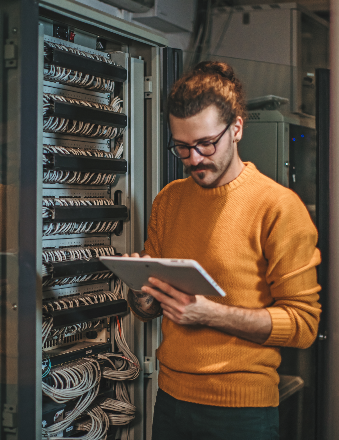 Man using tablet in server room.