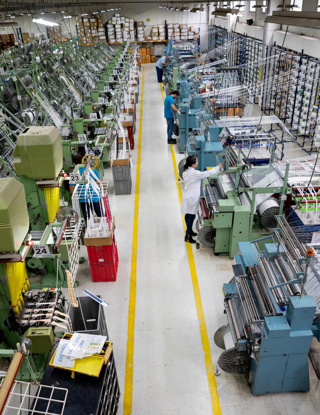 Textile factory with workers operating machinery.