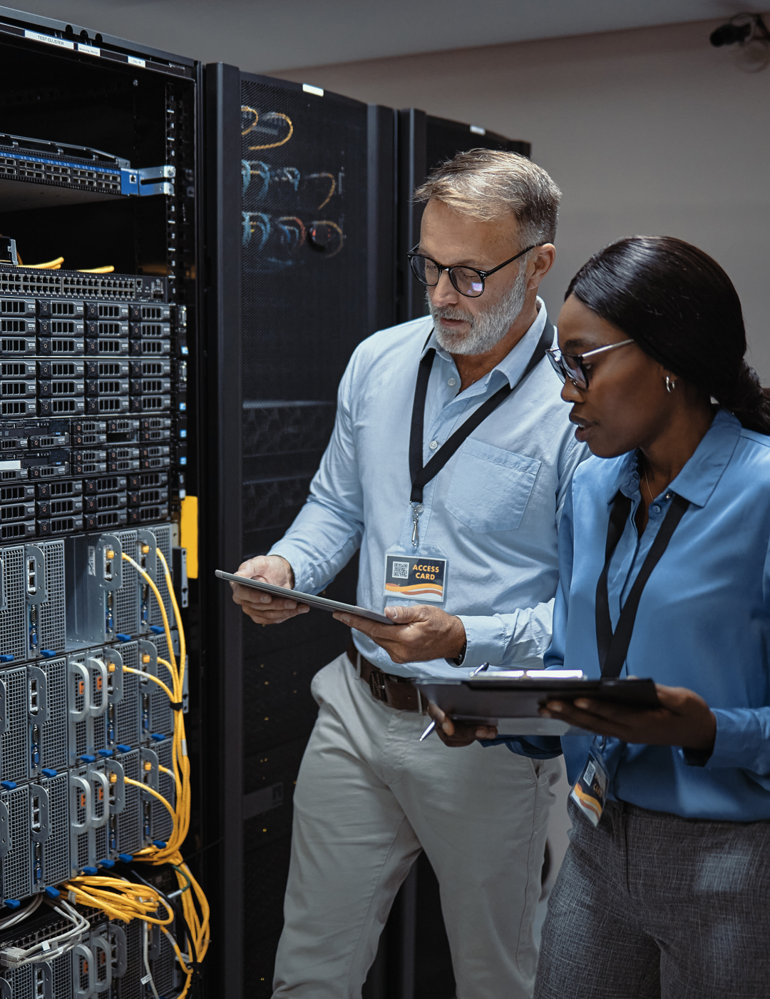 Two professionals analyzing server equipment.