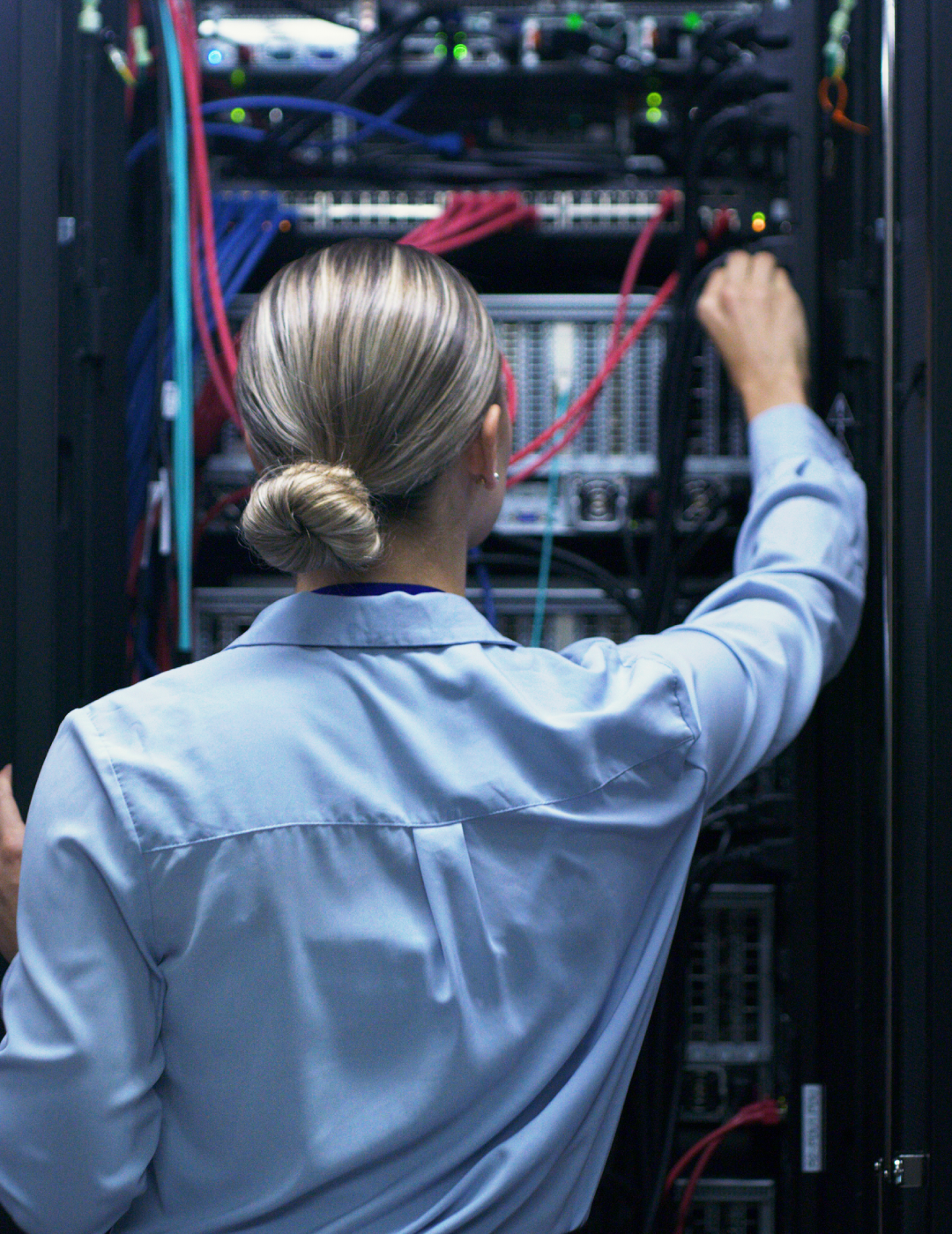 Woman working on server equipment.