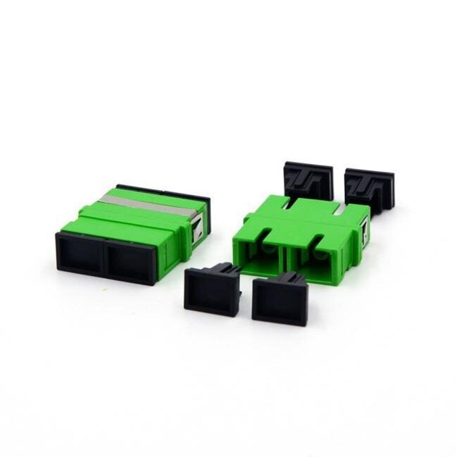 Green fiber optic adapters with black caps.