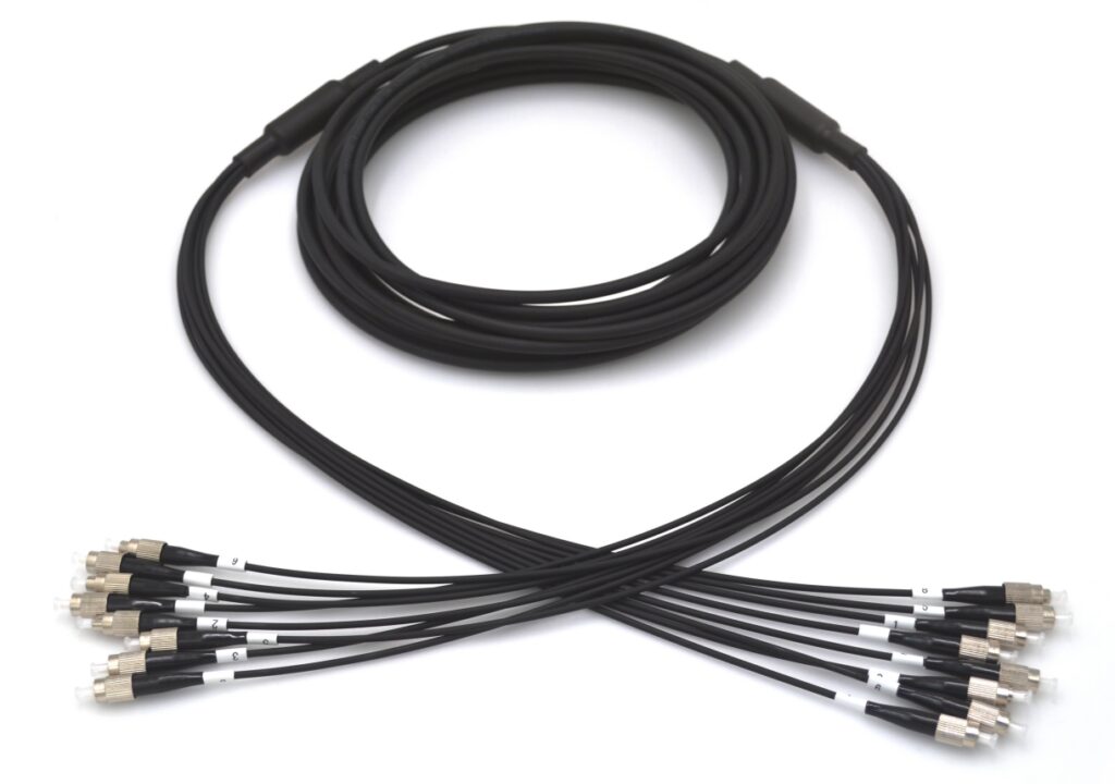 Coiled black cable with multiple connectors.