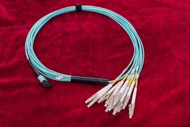 Fiber optic cable on red velvet background.