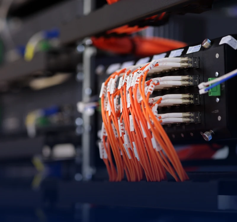 Orange network cables in a server rack.