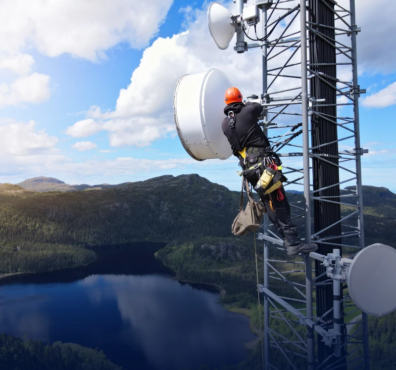 Technician working on a telecommunications tower.