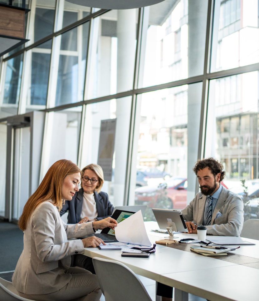 Three professionals working in a modern office.